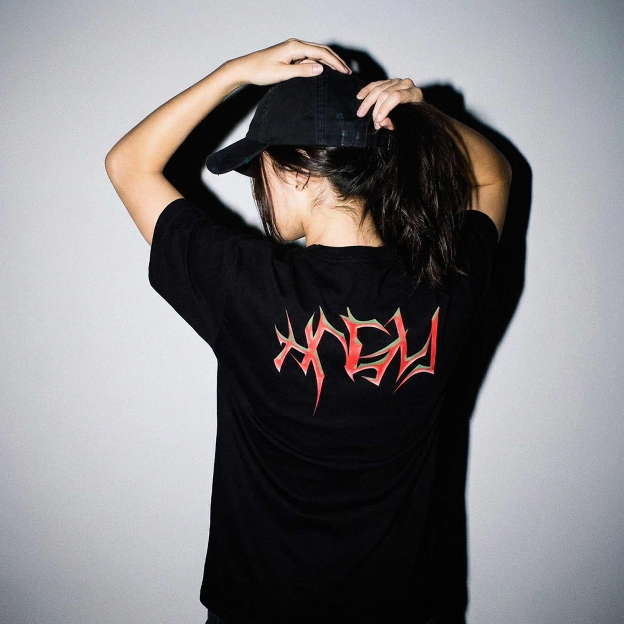 Back view of the HNGY oversized t-shirt with red flame graphic design.